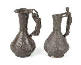 Two Charles Theodore Perron pewter jugs with lady shaped handles, signed to base. Approx 22 cm