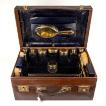 Asprey of London - a George V silver-gilt leather travelling vanity case, comprising two hand