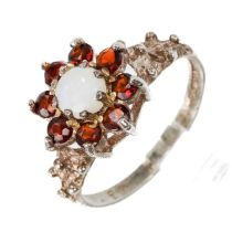A silver opal and garnet ring, size L, total gross weight approx 1.9g Good condition, wear and