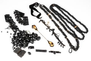 A collection of Victorian jet jewellery, including loose faceted beads, two bracelets, two brooches;