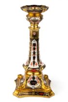 A Royal Crown Derby Old Imari 1128 solid gold band candlestick, heavily gilded with dolphin detail