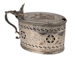 A George III silver mustard pot and cover, Robert Hennell, London 1784, with blue glass liner,