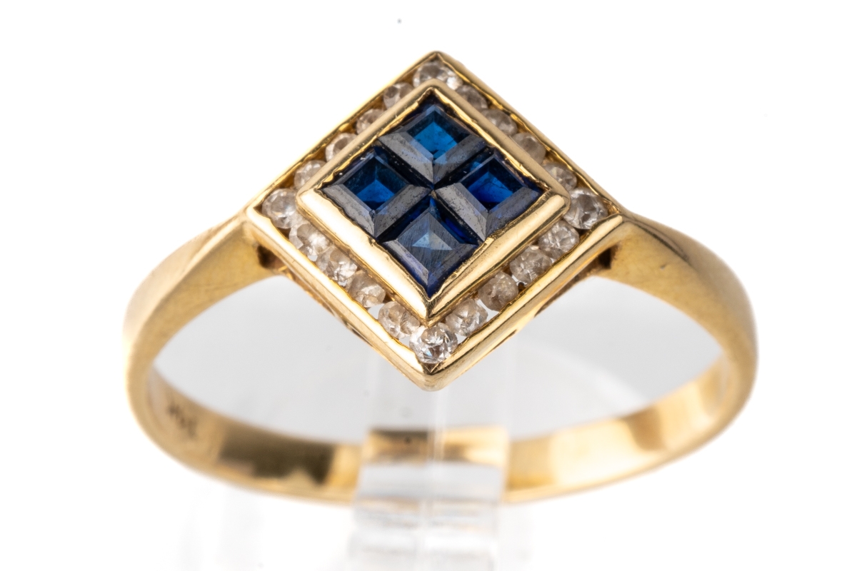 A 14k yellow gold sapphire and diamond ring, set with four square-cut sapphires surrounded by