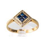 A 14k yellow gold sapphire and diamond ring, set with four square-cut sapphires surrounded by