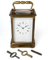 A 19th century brass carriage clock, striking on a gong, with two keys, 13cm high without handle