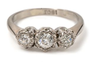 An 18ct white gold and diamond three-stone ring, illusion set old-cut diamonds, ring size M, total