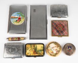 A collection of compacts and cigarette cases, including circular white metal compact with