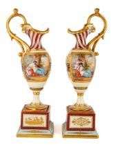 A pair of late 19th century Vienna porcelain pedestal ewers, each of Neo-Classical tapering