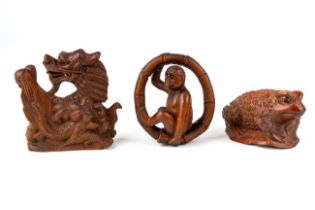 Three Japanese carved netsuke figures including dragon, toad and a monkey, signatures to base In