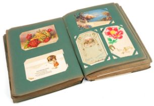 A large post card album, containing approx 500 postcards and birthday cards, some hand tinted, circa