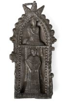 A cast metal wall hanging shrine, the hinged front cast with figures opening to reveal a figure of a