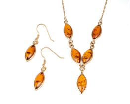A 9ct yellow gold and amber necklace and earrings set, the necklace set with five marquise