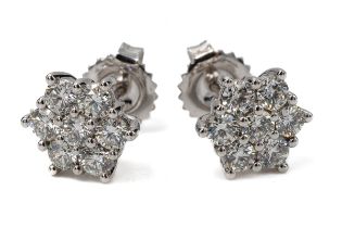 A pair of 18ct white gold and diamond floral cluster stud earrings, each earring set with seven