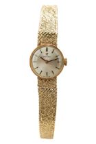 A ladies 9ct yellow gold Omega wristwatch, the circular silvered dial with baton indicators,