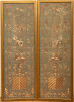 A pair of antique Chinese embroided silk panels, depicting dragons, Ho Ho birds and Shi Shi, in gold