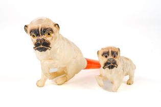 Two antique carved meerschaum pipe /cheroot holders in the form of pug dogs, in original leather