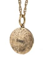 A 19th century yellow metal circular mourning pendant, the cased chased and engraved with foliate