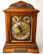 An Edwardian bracket clock, in honey coloured oak, gilt metal detail to face, key to front and