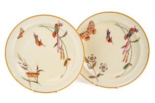 A rare pair of Wedgwood cream ware plates, decorated with exotic birds and butterflies, stamped to