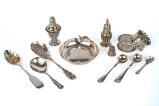 A collection of silver including napkin rings, pepperettes, assorted spoons, continental thimble,