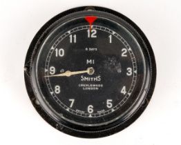 A Smiths bezel wind car clock M1, black case, approx 7.3cm diameter Currently ticking but no