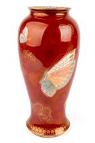A Carlton Ware ovoid vase, decorated with butterflies and moths on a red ground, black stamp to