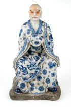 A late 18th/ early 19th century Chinese porcelain hand painted blue and white figure of a seated