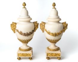 A pair of ormolu and marble cassolettes with the heads of Baccas amongst vines, in the manor of