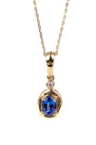 A 14k yellow gold tanzanite and diamond oval pendant, on a fine gold chain, total gross weight