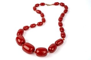 A cherry amber bead necklace, weight 60g, largest bed measures approx. 27mm x 20mm, grain visible