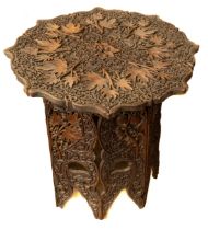Eastern carved hardwood folding table, approx. 61 cm tall and diameter 66 cm. In need of a clean