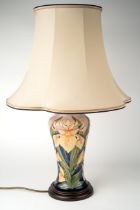 A Moorcroft 'Windrush Iris' pattern lamp, designed by Debbie Hancock, on a wooden base, approx