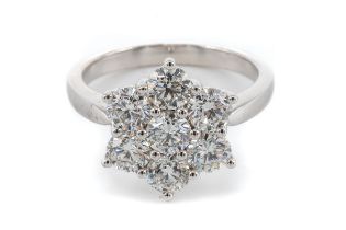An 18ct white gold and diamond seven-stone floral cluster ring, set with round brilliant-cut