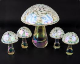 A set of five iridescent glass mushrooms, tallest 15cm, other four 8cm high (5) All in good