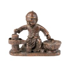 A bronze Chinese figure of a boy with 3 character mark to base and writing on sides . 7.5 x 6.5 cm