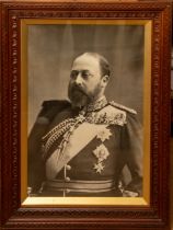 A pair of large photographic portraits of King Edward VII and Queen Alexandra in carved wood frames,