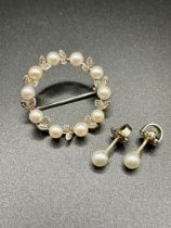 A white metal and pearl circular wreath brooch, set with ten 4mm cultured pearls with textured