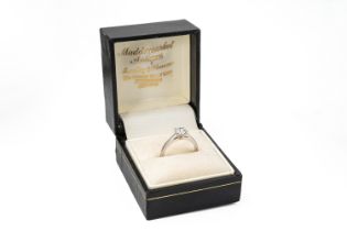 A platinum and diamond solitaire ring, the round brilliant-cut diamond approx 0.60ct, clarity
