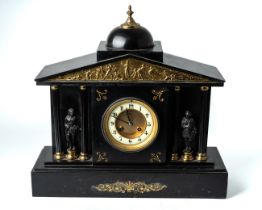A late 19th century French black slate mantle clock, circular enamel chapter ring with Arabic