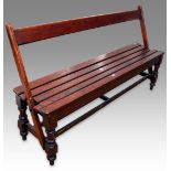 An early 20th Century slatted wood tram bench with reversible back rest, on turned supports, 150cm