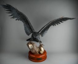 Roy Whitmore : a patinated welded steel sculpture of an eagle with wings outstretched landing on