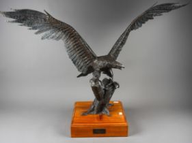 Roy Whitmore :a patinated welded steel sculpture of an eagle with wings outstretched, perched on a