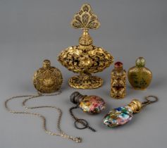 A collection of gilt metal mounted scent and snuff bottles, including a Chinese snuff bottle with