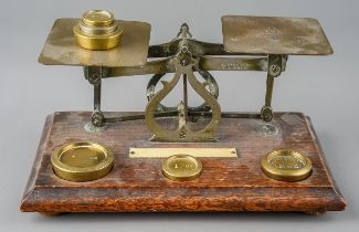 A pair of vintage postal scales with various weights wear commensurate with age and use