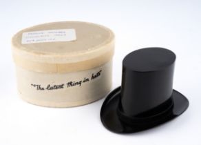 A vintage black Bakelite top hat perfume bottle holder, stamped Savile Reg No 820773, in oval box