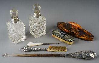 A pair of cut glass silver mounted dressing table scent bottles; silver handled button hook;