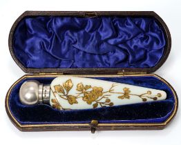 A Victorian silver mounted opaque glass scent bottle, of conical form with gilt foliate detail,