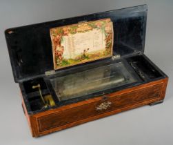 A 19th Century Swiss cylinder music box plays ten tunes, the cover inlaid with flowers, the interior