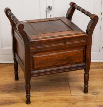 A 19th Century mahogany commode, hinged cover opens to reveal ceramic pot, with turned handles and