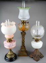 A collection of three Victorian style oil lamps with shades and a spare shade (3)